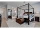 Spacious bedroom with a four-poster bed, area rug, and ensuite bath at 7416 Deschutes Cir, Las Vegas, NV 89129