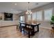 Open-concept dining area leads to the living room and features a rustic table with a chandelier at 7416 Deschutes Cir, Las Vegas, NV 89129
