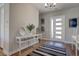 Bright entryway featuring a console table, contemporary decor, and a modern front door at 7416 Deschutes Cir, Las Vegas, NV 89129