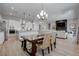 Open-concept layout featuring a dining area and kitchen with a rustic table and stainless appliances at 7416 Deschutes Cir, Las Vegas, NV 89129