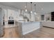 Modern kitchen features white cabinets, stainless steel appliances, and a large marble-top island at 7416 Deschutes Cir, Las Vegas, NV 89129