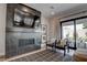 Living area features a fireplace with a flatscreen TV, stylish chairs, and natural light at 7416 Deschutes Cir, Las Vegas, NV 89129