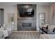 Living room with fireplace, flatscreen TV, comfortable seating, and a view of the backyard at 7416 Deschutes Cir, Las Vegas, NV 89129