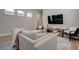 Cozy living area featuring neutral tones, plush seating, and a large TV for entertainment at 7416 Deschutes Cir, Las Vegas, NV 89129
