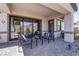 Inviting covered patio with paved flooring, stylish seating, and seamless access to the home interior at 7416 Deschutes Cir, Las Vegas, NV 89129