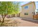 Spacious backyard featuring a covered patio, stucco siding, well-maintained landscaping, and partial fencing at 7736 Foredawn Dr, Las Vegas, NV 89123