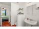 Bathroom features floating shelves, mirror, modern sink, and a view into the bedroom and walk-in shower at 7736 Foredawn Dr, Las Vegas, NV 89123