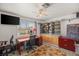 This bedroom has an office space, a ceiling fan, a window and built-in shelves at 7736 Foredawn Dr, Las Vegas, NV 89123