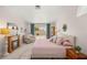 Bedroom featuring a fireplace, sitting area, and sliding glass door to the backyard patio at 7736 Foredawn Dr, Las Vegas, NV 89123