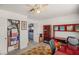 This bedroom features a closet, a doorway to another room, a ceiling fan, and a desk at 7736 Foredawn Dr, Las Vegas, NV 89123