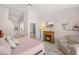 Bright bedroom with an en suite bathroom, a cozy fireplace, and a comfortable sitting area at 7736 Foredawn Dr, Las Vegas, NV 89123