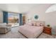 Comfortable bedroom with patio access and a cozy seating area, filled with natural light at 7736 Foredawn Dr, Las Vegas, NV 89123