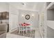 Cozy dining area boasts a decorative rug, table with four chairs, and natural light from French doors at 7736 Foredawn Dr, Las Vegas, NV 89123