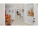 Inviting entryway with tile floors, neutral walls, and a view into the living room with a fireplace at 7736 Foredawn Dr, Las Vegas, NV 89123