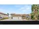 Charming two-story home featuring a three-car garage, desert landscaping, and a classic tile roof at 7736 Foredawn Dr, Las Vegas, NV 89123