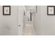 Bright hallway with neutral paint and tile flooring, enhanced by decorative wall art at 7736 Foredawn Dr, Las Vegas, NV 89123