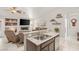 Open concept living space with granite counters, stainless appliances, and a cozy fireplace with built-in shelves at 7736 Foredawn Dr, Las Vegas, NV 89123