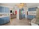 Open kitchen featuring stainless steel appliances, blue cabinets, and an open floor plan to the living area at 7736 Foredawn Dr, Las Vegas, NV 89123