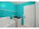 Laundry room with a washing machine, a dryer, and wire shelving at 7736 Foredawn Dr, Las Vegas, NV 89123