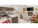 Open concept living area with granite counters, stainless appliances, and a cozy fireplace with built-in shelves at 7736 Foredawn Dr, Las Vegas, NV 89123