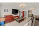 Cozy living room featuring a sectional sofa, a large television, and built-in shelves at 7736 Foredawn Dr, Las Vegas, NV 89123