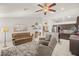 Comfortable living space showcasing a cozy seating area, fireplace, and seamless flow into the modern kitchen at 7736 Foredawn Dr, Las Vegas, NV 89123