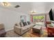 Inviting living room with a sectional sofa, a large window, and sliding glass doors to the backyard at 7736 Foredawn Dr, Las Vegas, NV 89123