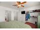 Main bedroom showcasing closet with organizers, ceiling fan, and a view into the ensuite bathroom at 7736 Foredawn Dr, Las Vegas, NV 89123