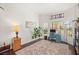 Well-lit home office with wood floors, a large window, and a comfortable workspace at 7736 Foredawn Dr, Las Vegas, NV 89123