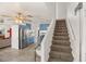 View of staircase leading upstairs, stainless steel refrigerator, and kitchen with blue cabinets in view at 7736 Foredawn Dr, Las Vegas, NV 89123