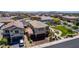 Aerial view of the home, neighborhood, and the park next door, featuring a sidewalk, a grassy field, and benches at 7824 Warm Winds St, North Las Vegas, NV 89084