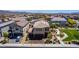 Aerial view of the home, neighborhood, and the park next door, featuring a sidewalk, a grassy field, and benches at 7824 Warm Winds St, North Las Vegas, NV 89084