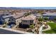 Aerial view of the home, neighborhood, and the park next door, featuring a sidewalk, a grassy field, and benches at 7824 Warm Winds St, North Las Vegas, NV 89084
