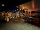 Night view of a cozy backyard with patio, desert landscaping, and string lights at 7824 Warm Winds St, North Las Vegas, NV 89084