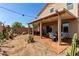 Spacious backyard with desert landscaping and a covered patio with a dining set at 7824 Warm Winds St, North Las Vegas, NV 89084