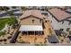 Aerial view of the backyard, featuring a covered patio with seating, a desert-style yard, and a block fence at 7824 Warm Winds St, North Las Vegas, NV 89084