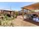 Expansive backyard features desert landscaping, a covered patio, and a cozy gazebo at 7824 Warm Winds St, North Las Vegas, NV 89084