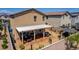 Aerial view of the backyard, featuring a covered patio with seating, a desert-style yard, and a block fence at 7824 Warm Winds St, North Las Vegas, NV 89084