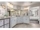 Bright bathroom with double sinks, granite countertop and large mirrors at 7824 Warm Winds St, North Las Vegas, NV 89084