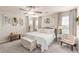 Bright bedroom with large windows, ceiling fan, neutral décor, and comfortable furnishings at 7824 Warm Winds St, North Las Vegas, NV 89084