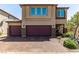 Charming two-story home with a two-car garage and brick-paved driveway, enhanced by meticulous landscaping at 7824 Warm Winds St, North Las Vegas, NV 89084