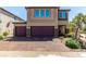 Charming two-story home with two-car garage and brick-paved driveway, complemented by well-maintained landscaping at 7824 Warm Winds St, North Las Vegas, NV 89084