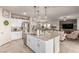 Open-concept kitchen with a granite island, stainless appliances, and seamless flow to the living area at 7824 Warm Winds St, North Las Vegas, NV 89084