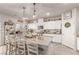 Spacious kitchen with a large island, granite countertops, pendant lighting, and modern appliances at 7824 Warm Winds St, North Las Vegas, NV 89084