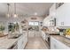 Well-lit kitchen showcasing white cabinetry, granite countertops, and stainless steel appliances at 7824 Warm Winds St, North Las Vegas, NV 89084