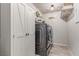 Convenient laundry room with modern washer and dryer units and ample storage space at 7824 Warm Winds St, North Las Vegas, NV 89084