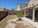 Fenced backyard with pergola-covered patio awaiting landscaping at 7849 Blue Brook Dr, Las Vegas, NV 89147