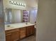 This bathroom features a double sink vanity, a shower-tub, and tile flooring at 7849 Blue Brook Dr, Las Vegas, NV 89147