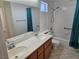 This bathroom has a large vanity, shower-tub combo, and tiled floors at 7849 Blue Brook Dr, Las Vegas, NV 89147
