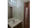Neutral bathroom vanity with sink, mirror, and adjacent doorway at 7849 Blue Brook Dr, Las Vegas, NV 89147